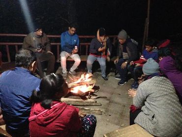 tourists sitting a fire place