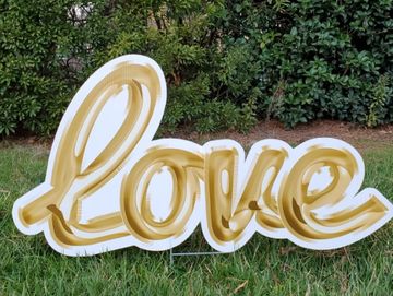 "love" in cursive yard sign