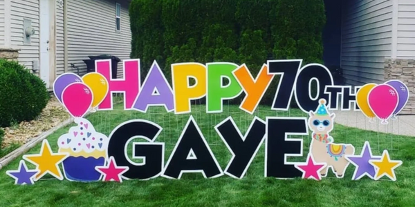 Custom yard card: "Happy 70th Gaye" with images of cakes, a llama, and balloons