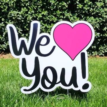 We love you yard card with pink heart. Anniversary yard card rental, graduation yard greeting Cary