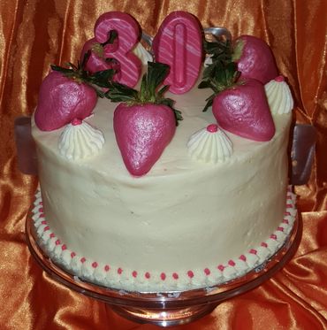 Vanilla Cake with Cream Cheese Frosting, decorated with strawberries.