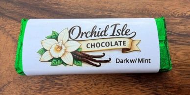 Orchid Isle Chocolate bar with dark and mint flavor wrapped in green and white packaging.
