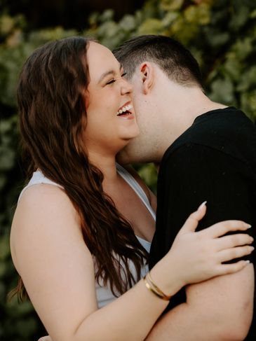 Couple sharing a joyful moment outdoors.