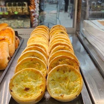 <img alt="quiches individuais expostas numa vitrine" src="...">