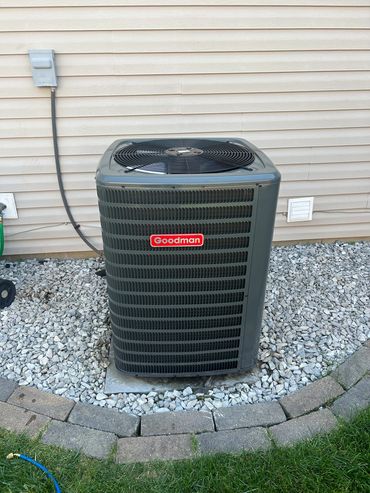 Goodman air conditioning unit outside a house.