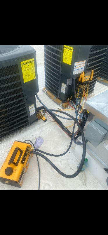 Air conditioning units with HVAC tools and gauges.