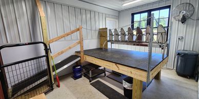 An indoor shooting range setup with targets and a raised platform.