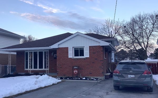Up front view of home with car parking