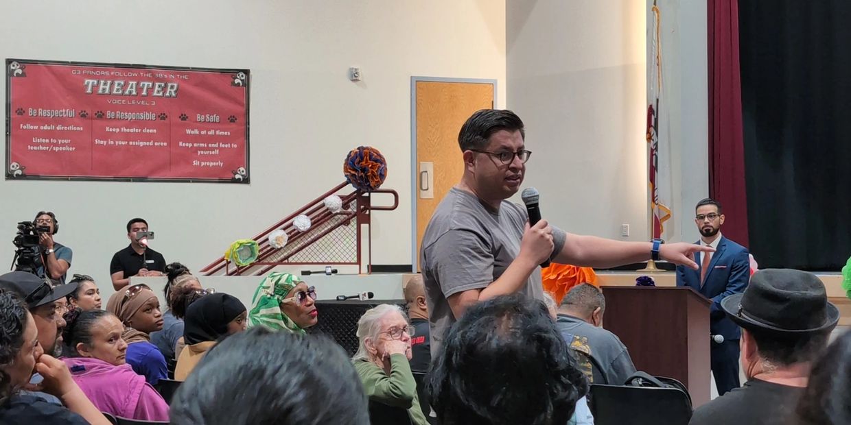 Speaker addressing a crowd in a theater.