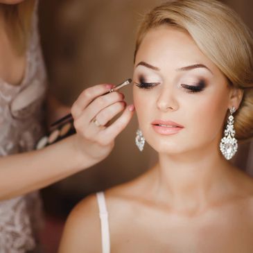 Woman having her eye makeup applied.