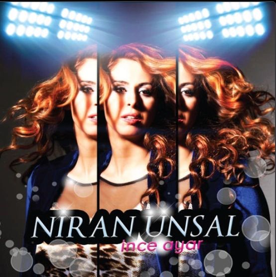 Niran Ünsal albüm kapağı, üçlü portre ve spot ışıkları.
