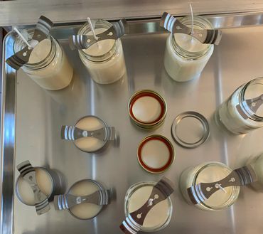 Warm candlelight shining from within a transparent glass vessel.