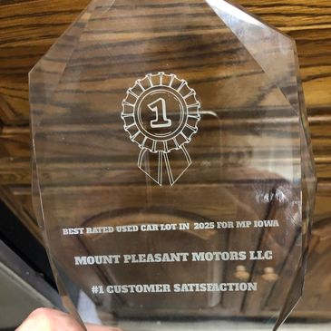 Award plaque for best rated used car lot in 2025.