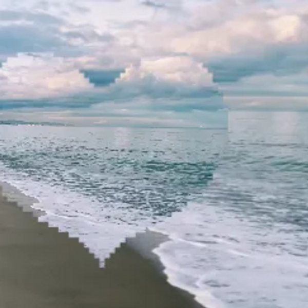 A pixelated heart shape overlays a serene ocean beach scene with cloudy skies.