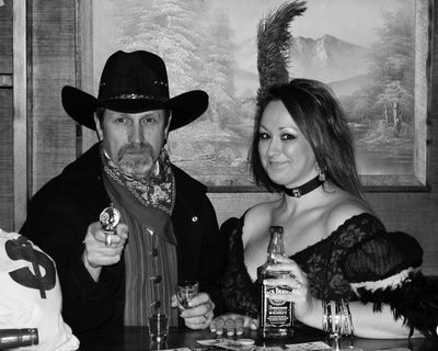 Saloon girl and her cowboy. whickey and guns and flirty women