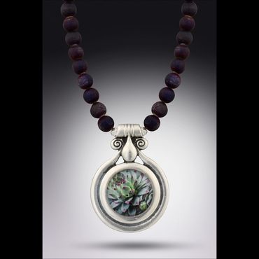 Sterling silver bezel from Portugal
hung on a strand of 14mm deep purple druzy agate mined in Brazil