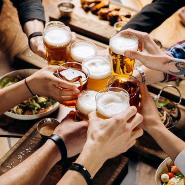 A group of people cheering in a pub