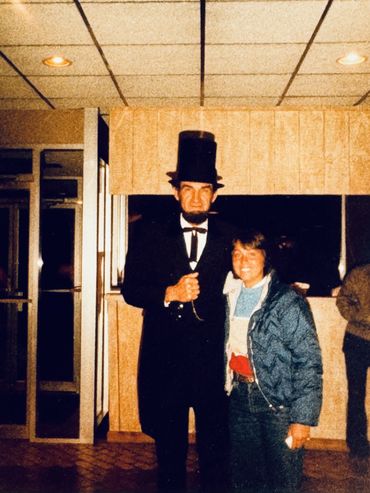 Picture of person dressed as Abe Lincoln with young girl