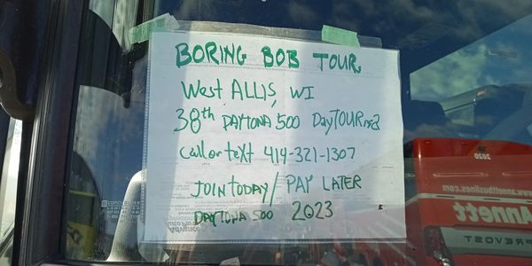 Sign in front window of MY shuttle BUS at the Daytona 500 - 2022 advertising my 38th year at DIS