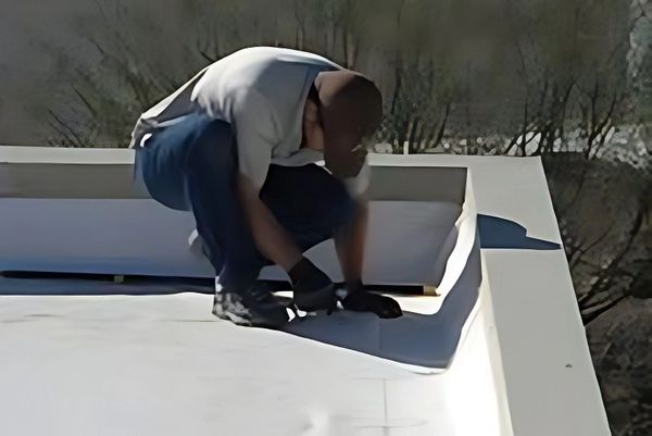 Photo of the owner installing a PVC roofing system.