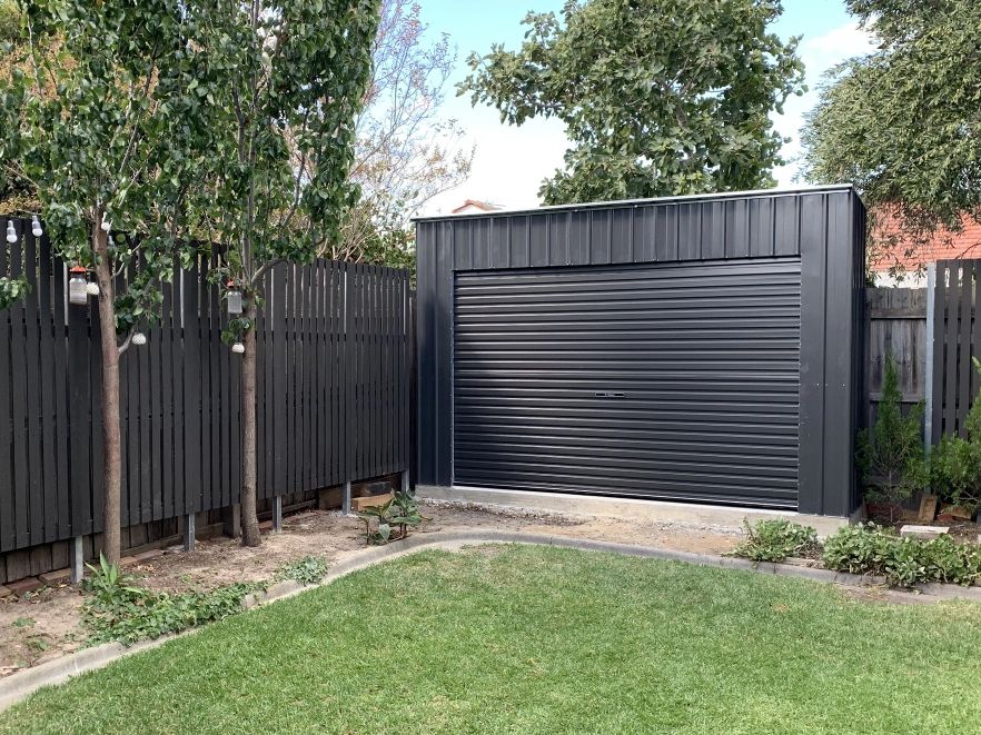 Heavy-duty steel-frame garden shed with roller door.