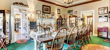 The indoor dining room at The Inn of the Patriots featuring a 14-foot long table.