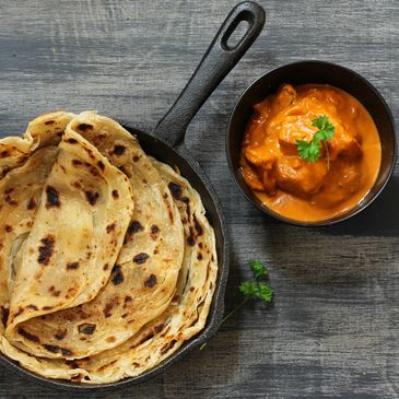 Hand-rolled Grilled fresh Chapati Bread with Stewed Lamb Butter Masala over Jyoti Basmati Rice.