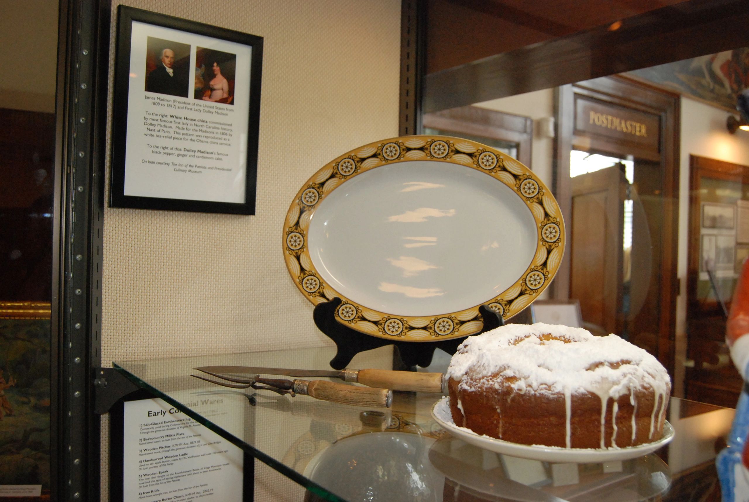 A picture of Dolley Madison's cake on display in a museum glass showcase.