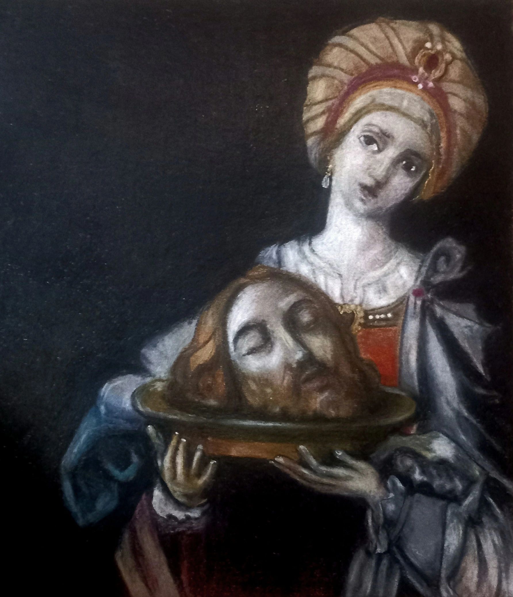 A woman solemnly holding a platter with a severed head in a dark setting.