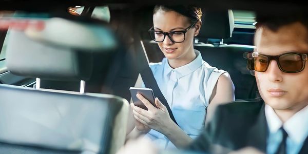 a business woman being chauffeured to her destination