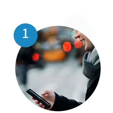 A gentleman standing in the winter making a reservation to reserve a limo service in Houston, TX.