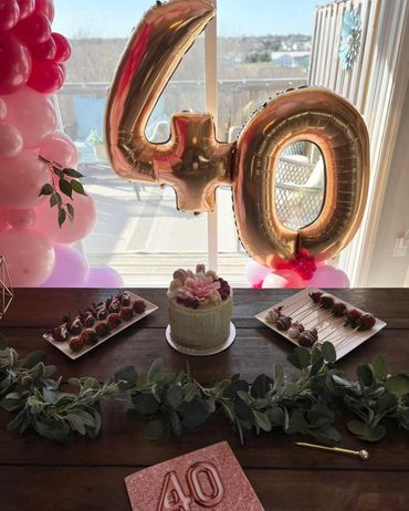 Beautiful golden "4" and "0" on a small cluster of pink, raspberry, and matte lilac balloons.