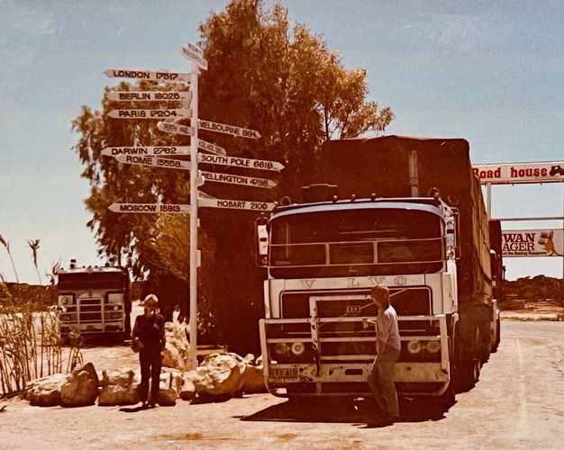 Film photo from 1985 travelling across Australia. Roadhouse, sign post, distance to major cities.