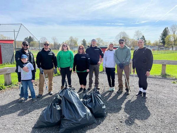 people posing with bags of garbage