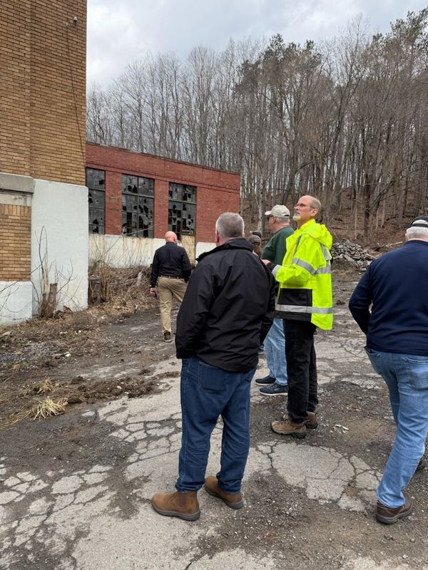 Construction contractors looking at the building.