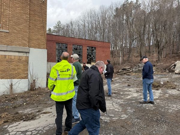 Construction contractors looking at the building.