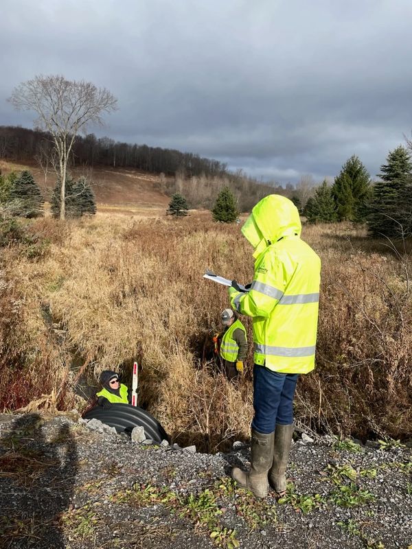 Samantha looking at a culvert