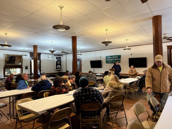 Community members listening at the public meeting.