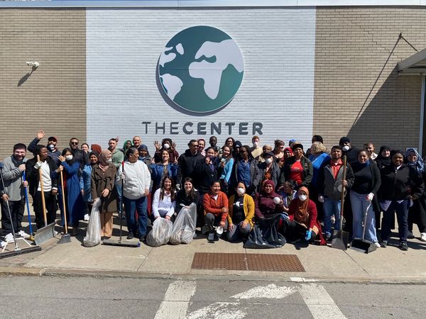 people posing in front of the Center during a cleanup