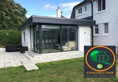 A modern kitchen, living room extension and new open outdoor space by TD in the Isle of Man