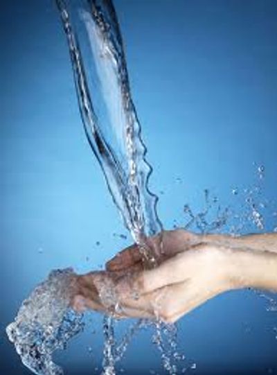 Image of water running onto a person's hand.  This photo has no links and is for aesthetic purposes
