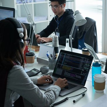 Two IT professionals working at a desk