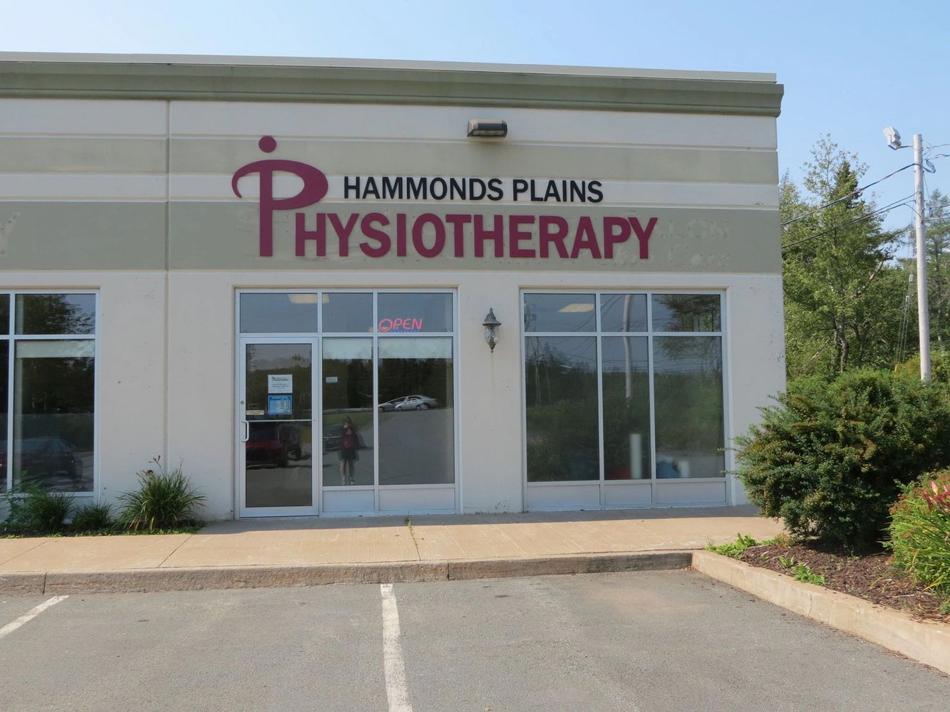 Two people reviewing documents with a pen and calculator on a desk.