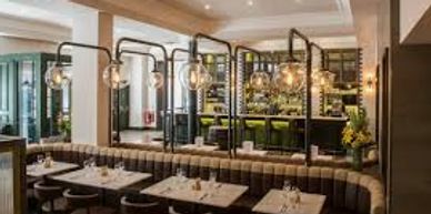Modern restaurant interior with cozy seating and warm lighting.