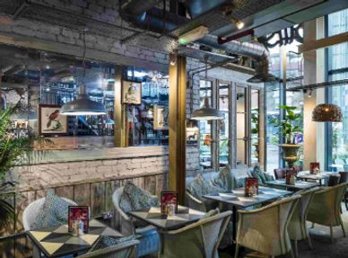 Cozy cafe interior with wooden furniture and soft lighting.