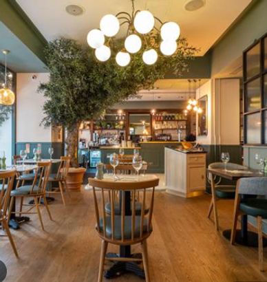 Cozy restaurant interior with wooden furniture and warm lighting.