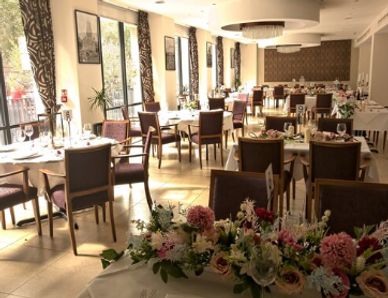 Elegant dining room with floral centerpieces and natural light.