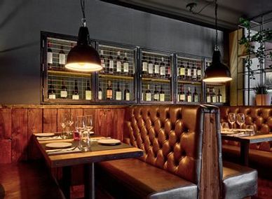 Cozy restaurant booth with leather seating and warm lighting.
