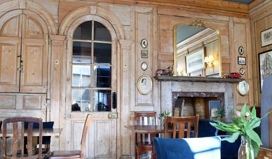 Cozy wooden interior of a vintage-style cafe with classic furniture.