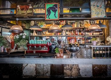 Cozy vintage café bar with warm lighting and eclectic decor.
